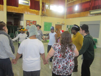 Choreographer Lauren Potter leads a circle dance at a secondary school for young people with special educational needs