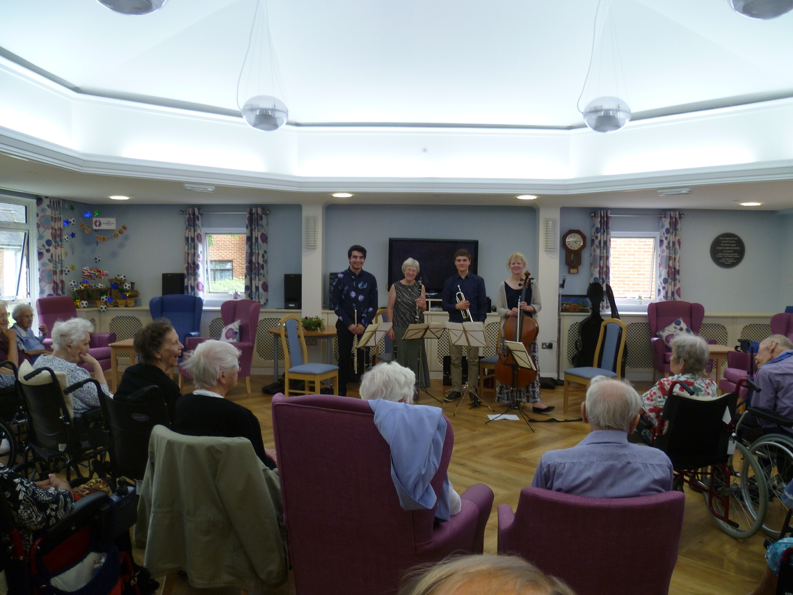 Young musicians from the Croydon Performing Arts Festival perform alongside Margaret and Julia at a Croydon care home