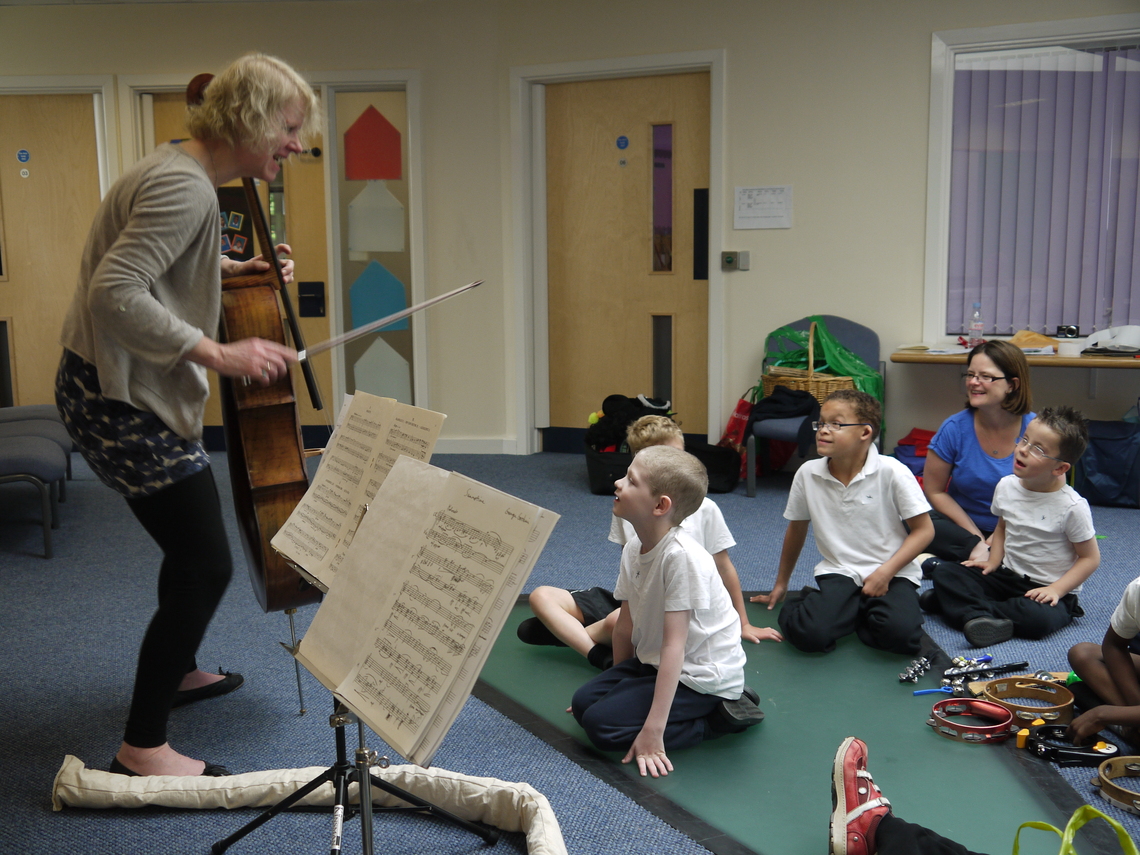 Julia introduces her cello to an eager group at St Nicholas School