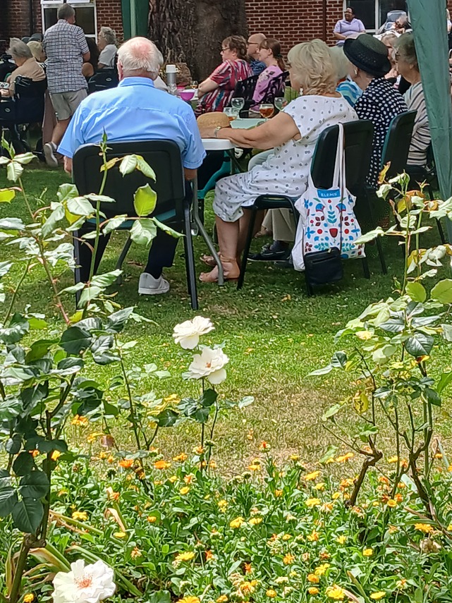 Audience under the trees in Whitgift House garden