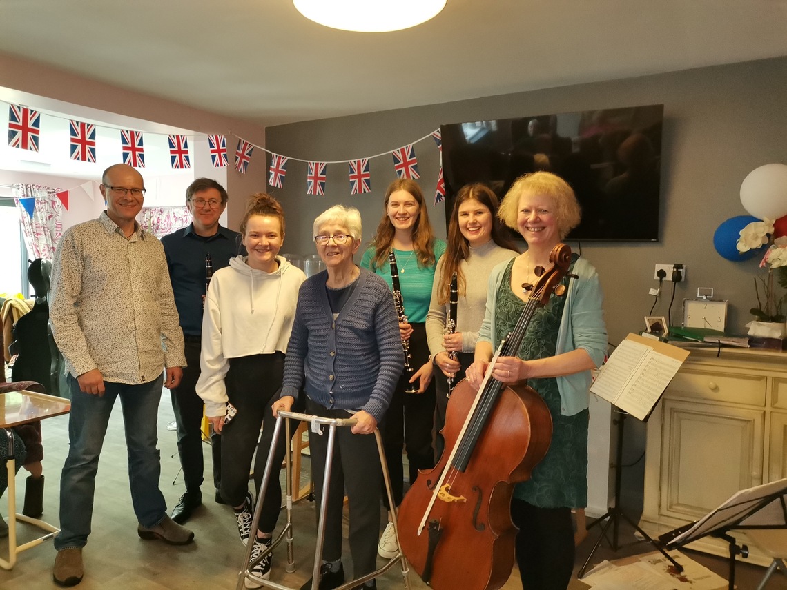 Our musicians pose with Rosemary and her family